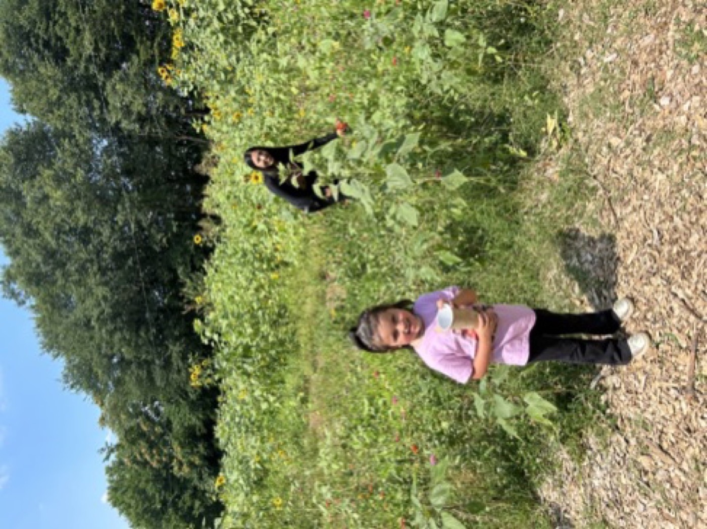 Nuri Icgoren at Urban Sprout Farms with young visitors in the flower field