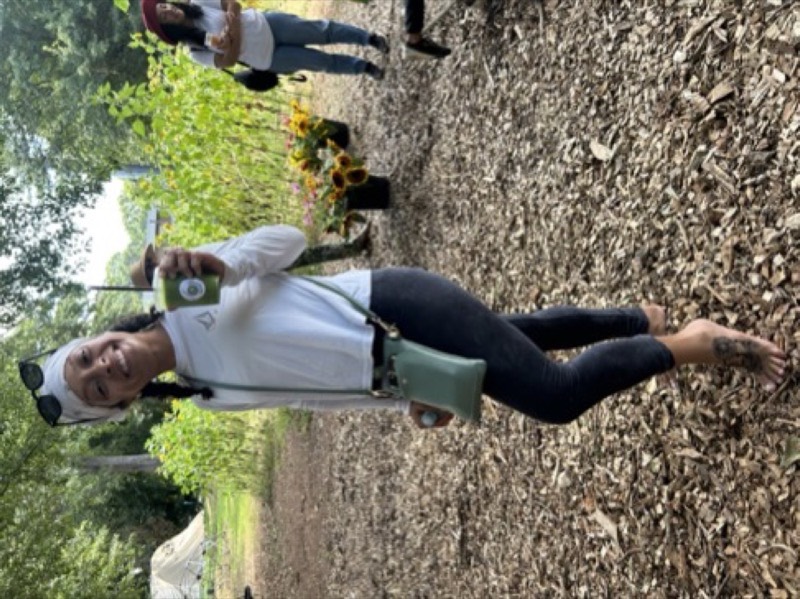 Guests with fresh garden drinks among the sunflowers at an Urban Sprout Farms evening workshop
